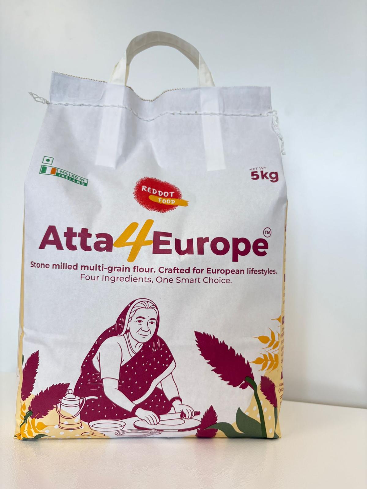 Pack of Reddot Food Multigrain Flour with ingredients like  whole wheat, oats, Amaranth and Horsegram on a wooden kitchen surface